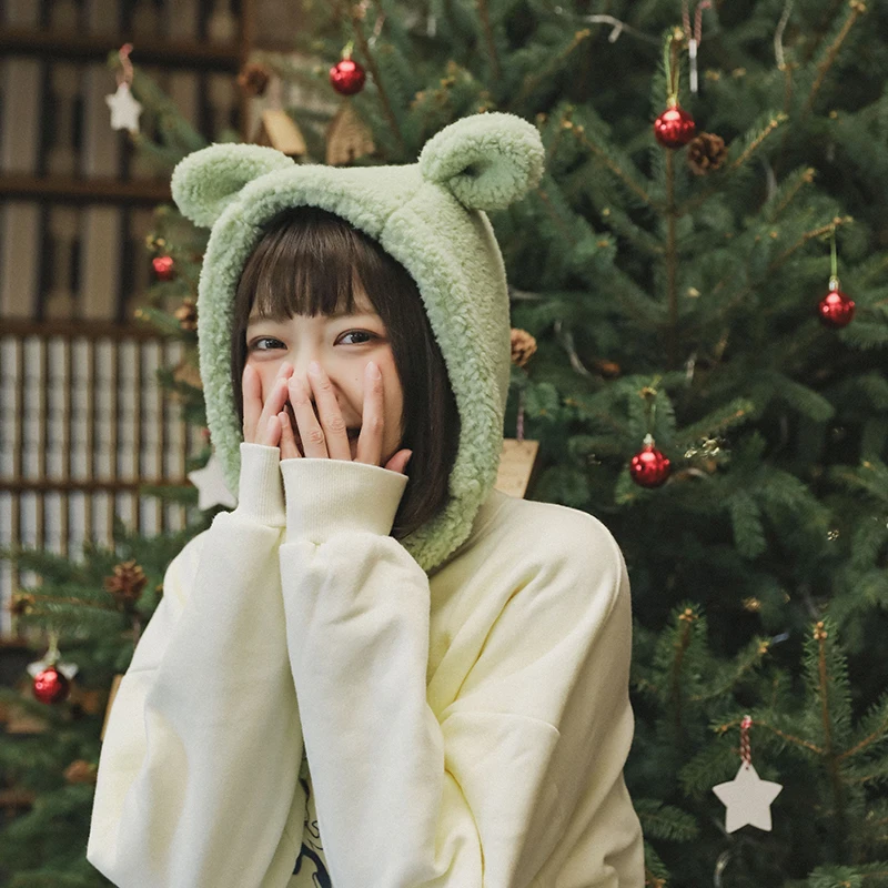 

A cute bear cub keeps his face small by keeping warm with a fluffy, strappy earmuff cap womens hats green hat