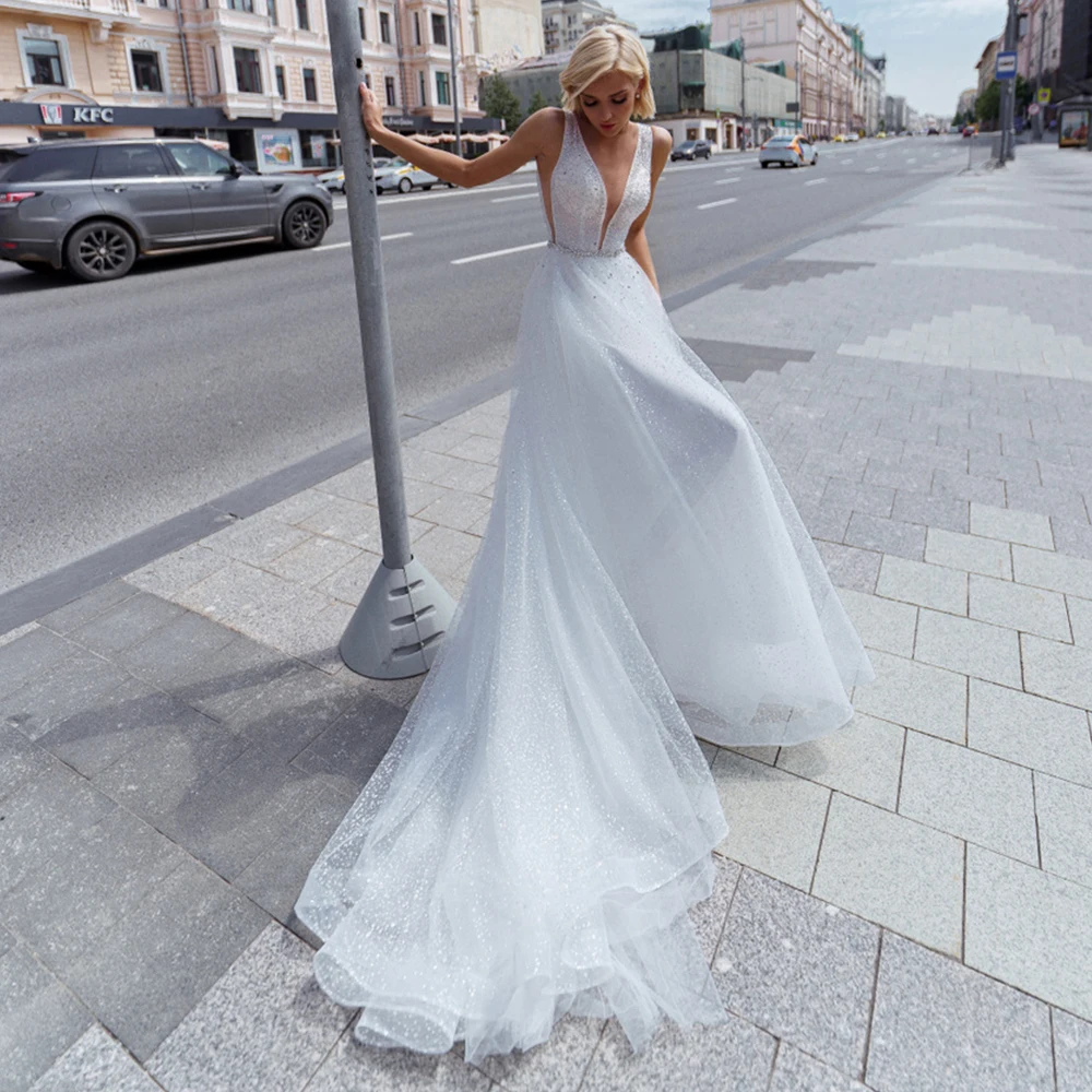 

Gorgeous A-Line Wedding Dresses V-Neck Tulle Sleeveless Sparkly Crystal Illusion Sequined Button Back Court Train Bridal Gowns