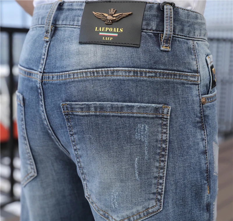 

2020 new summer personality eagle embroidery holes slim body small feet web celebrity trousers fashion popular logo jeans male