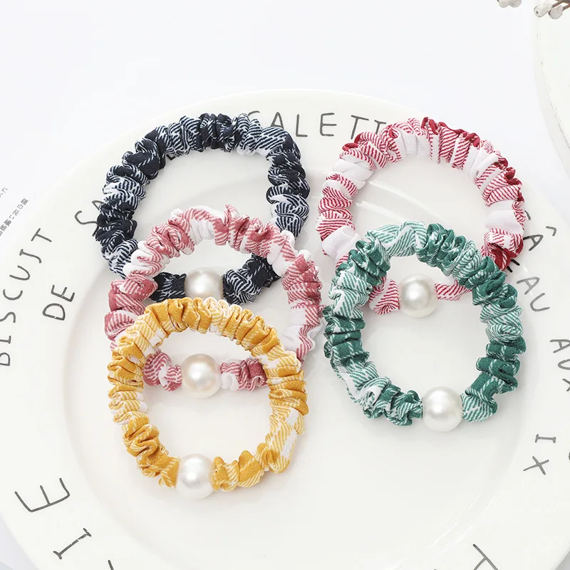 

100pcs / lot hair cord women's high elastic fabric with rubber band pearl hair band tie horsetail small intestine loop