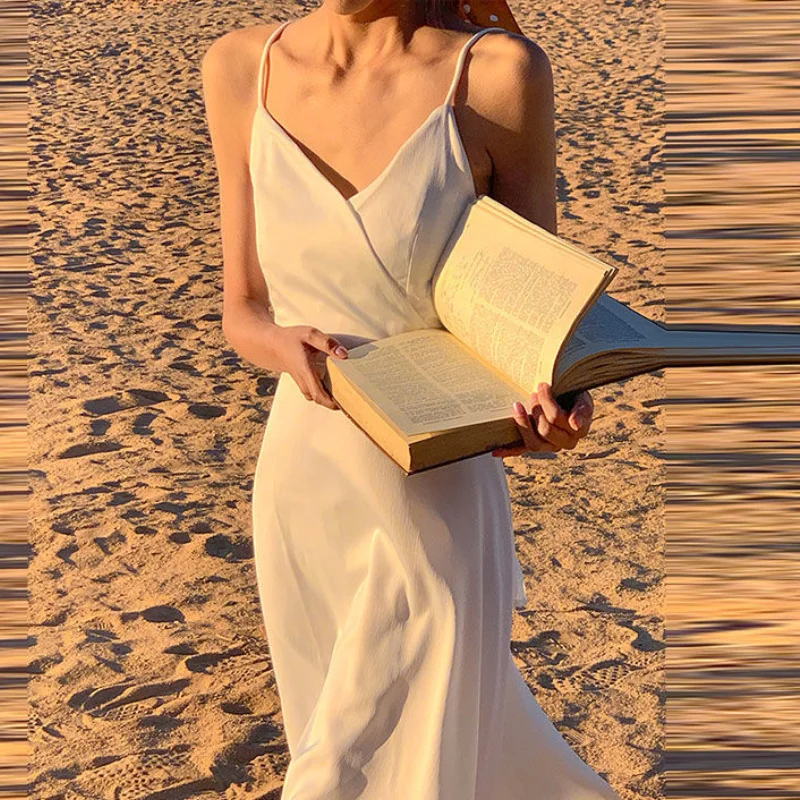 

INS Seaside Holiday Dress Women 's Summer 2021 New Super Fairy White Suspender Bare Back Skirt Desert Travel Photography