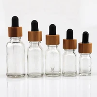 wholesale empty color glass round dropper bottles with bamboo cap essential oil perfume container for cosmetics