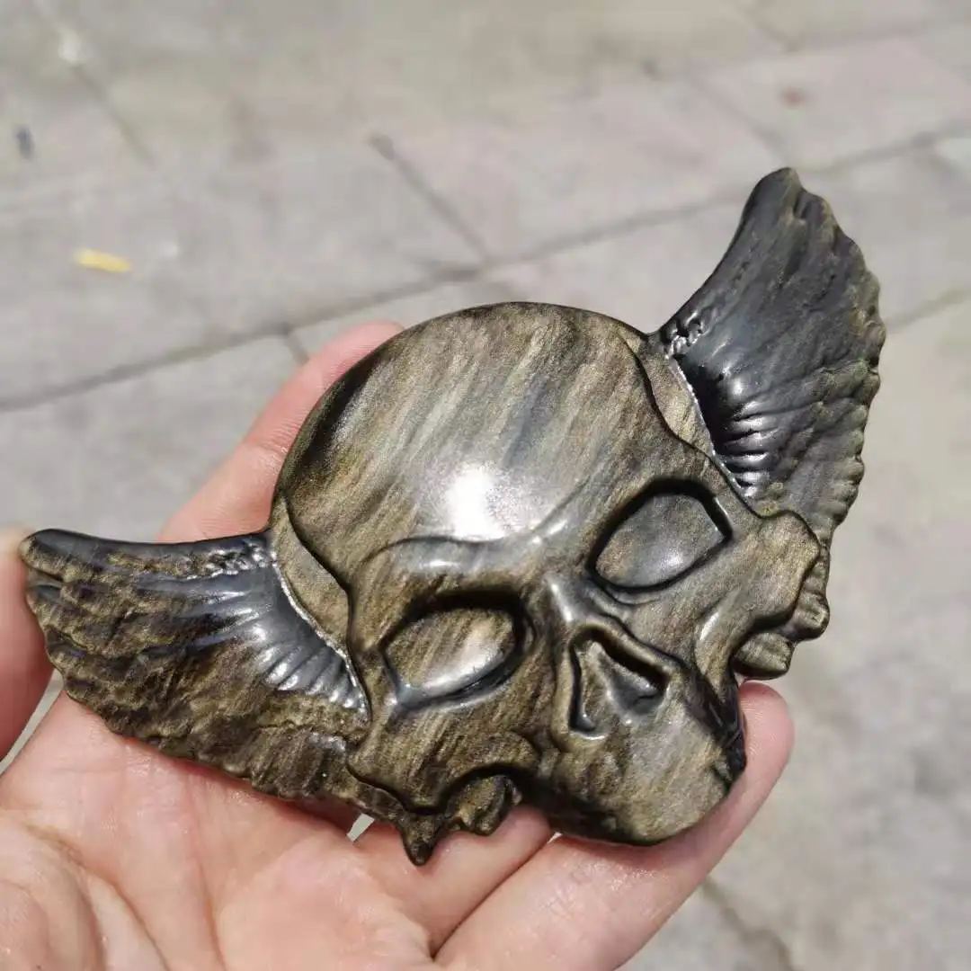

Natural Gold obsidian Skull Figurine Carved Gold obsidian skull with wings Statue Sculpture