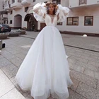 Классические свадебные платья из тюля со съемным пышным длинным рукавом трапециевидной формы с овальным вырезом