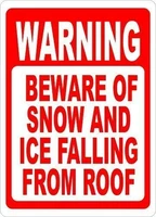 warning sign warning beware of snow ice falling from roof sign post for safety during bad winter weather road sign business