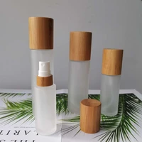 wholesale frosted glass bottles for cosmetics bottles with bamboo lid covered spray bottle mist