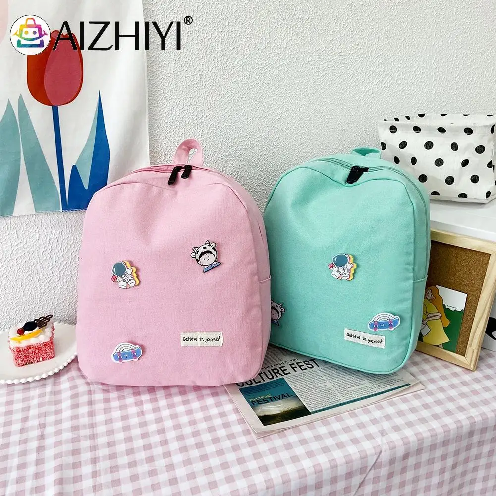 

Vintage Women Canvas Solid Color Backpack Casual Preppy Style Large Capacity Knapsack Rucksacks Handbags with Cartoon Badges