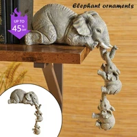elephant sitter hand painted resin figurines 3pcs mother and two babies hanging off the edge of shelf table stock