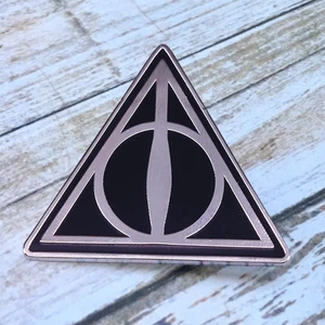 A small pin brooch featuring the Deathly Hallows symbol from the story of the Three Brothers. A must in Pakistan
