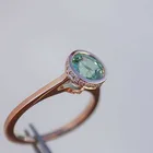 Кольцо круглое из розового золота с зелеными кристаллами