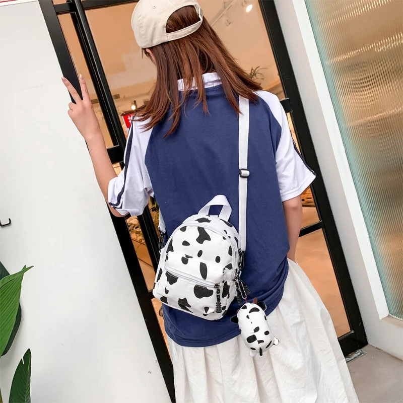 

Mini Canvas Daypack with Plush Pendant Cow Print Backpack For Women Lady Girls Outdoor Travel Shopping Shoulder Bag Bookbag