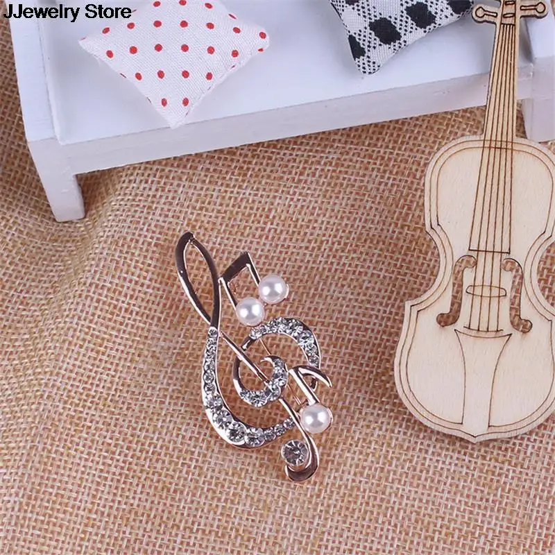 Элегантная брошь в форме музыкальной ноты с украшением виде кристаллов булавки