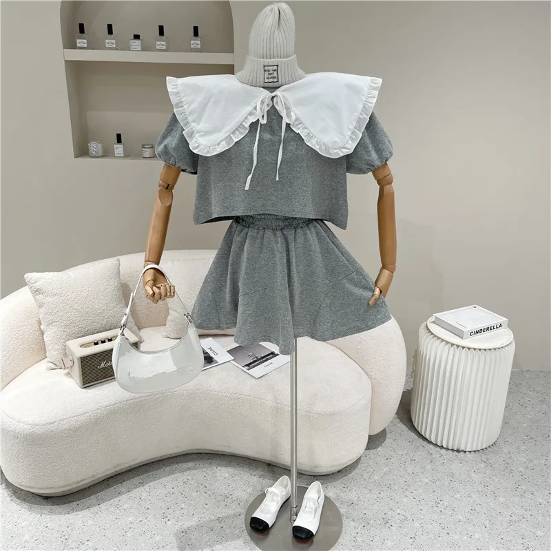 

Two Piece Set Women Summer 2021 Niche Design Fashion Loose Solid Shawl Round Neck Short Sleeve Top Casual High Waist Short Skirt