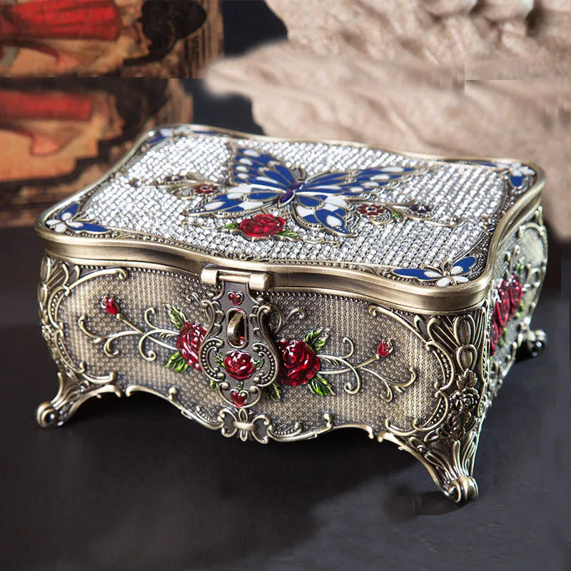 

Antique Brass Blue Red Zinc Alloy Trinket Box With Embossed Rose Flower Leaves Branch And Butterfly Texture On And Stones Inlaid