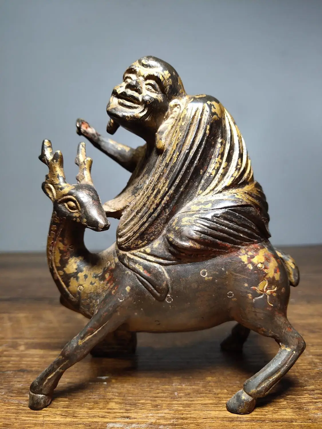 

5"Tibet Buddhism Temple Old Bronze Cinnabars Lacquer Arhat riding a spirit deer statue Implication Fairy guide Enshrine