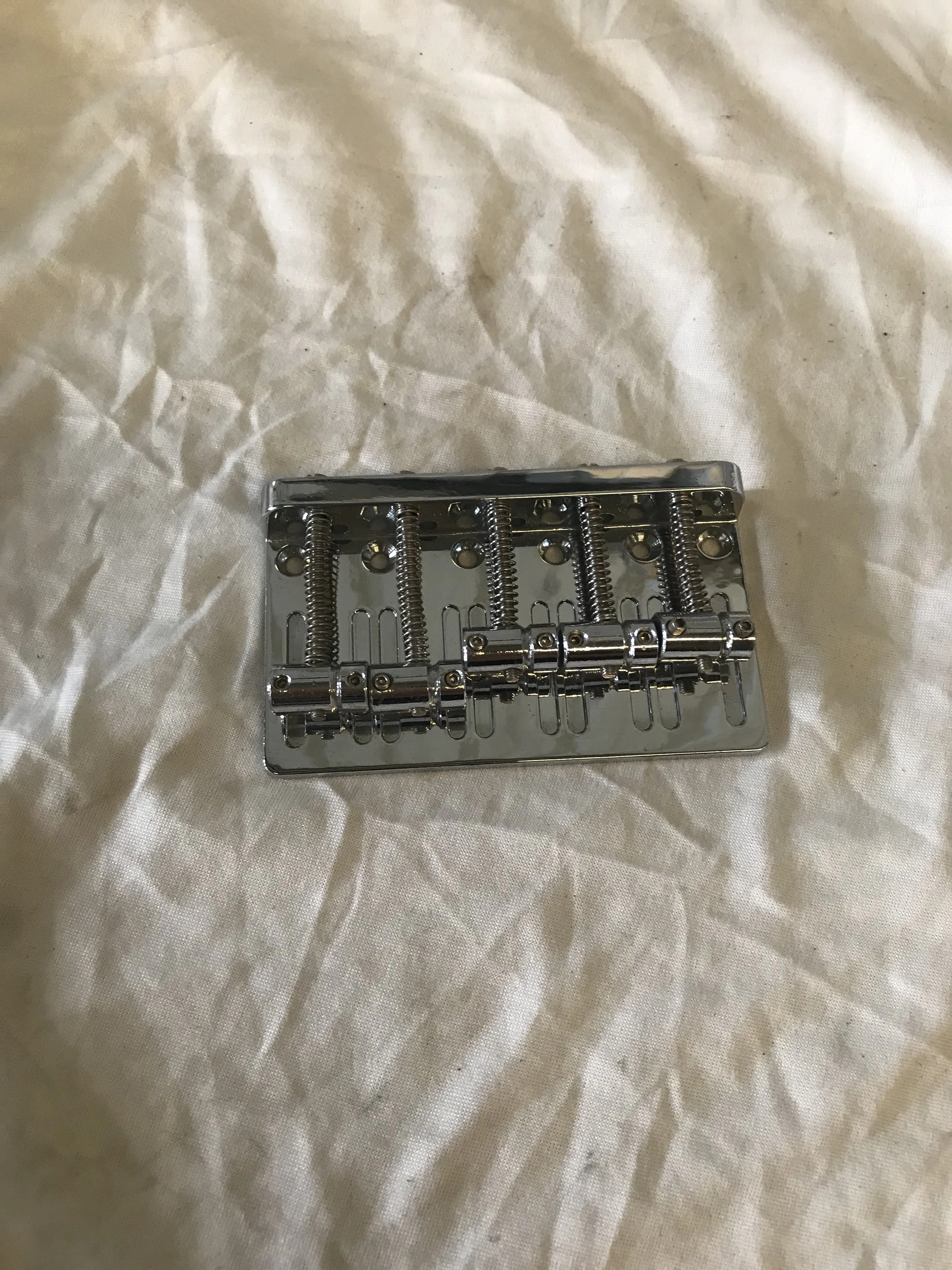 

A set of 5 Strings Electric Bass Bridge Silver Color Metal Saddle Bridge Guitar Parts Musical instruments accessories