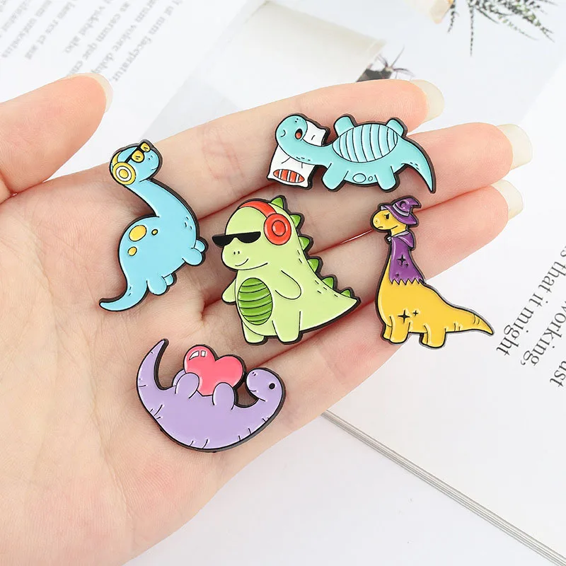 

Dinosaur and Books Enamel Pin Custom Reading Habit Animal Brooch Bag Clothes Lapel Pin Badge Cartoon Jewelry for Kid Friend