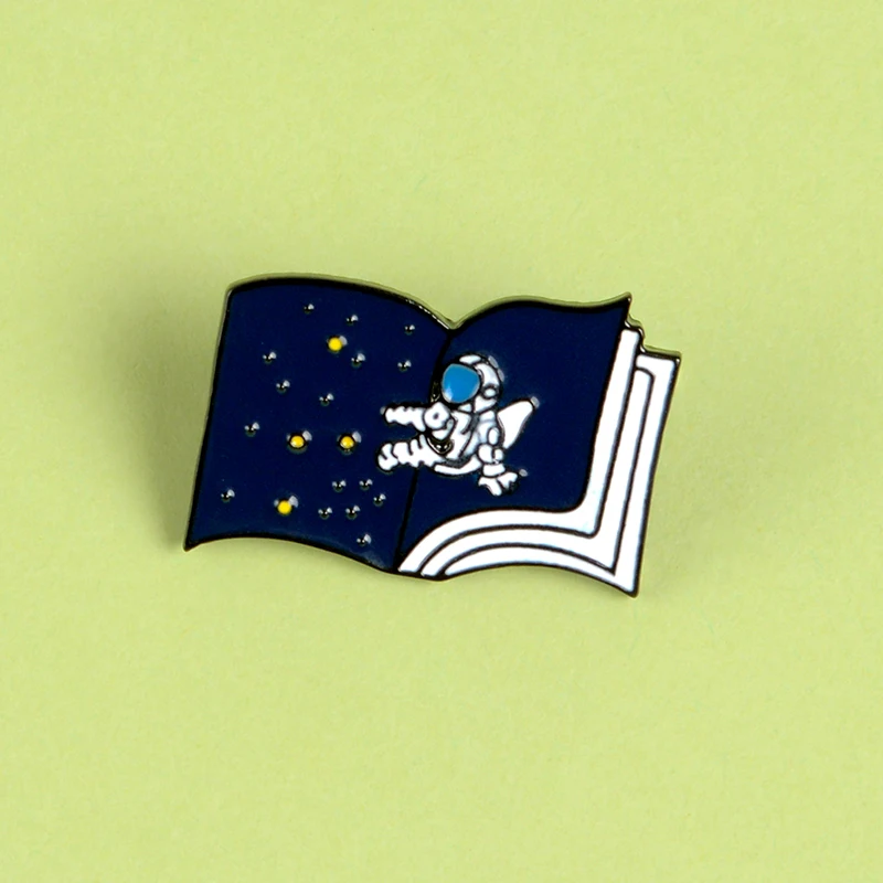

QIHE JEWELRY Space Travel in Book Enamel Pin Astronaut Brooches Lapel pins Badge Clothes Bag Reading Jewelry Gift for Bookworm