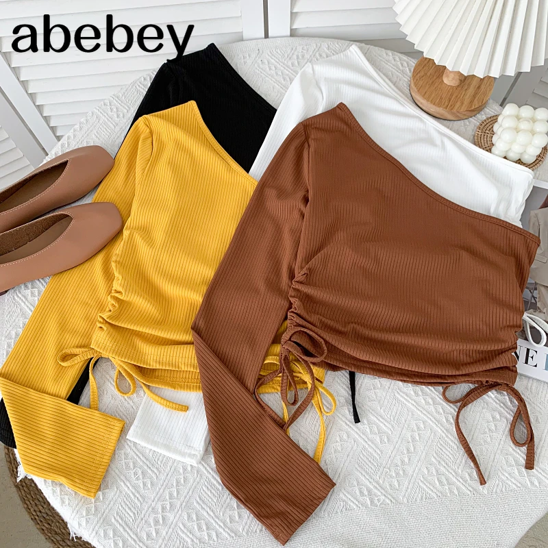 

Модная футболка с диагональным воротником и длинным рукавом, бандажная короткая футболка с высокой талией и открытыми плечами, топ на шнуро...