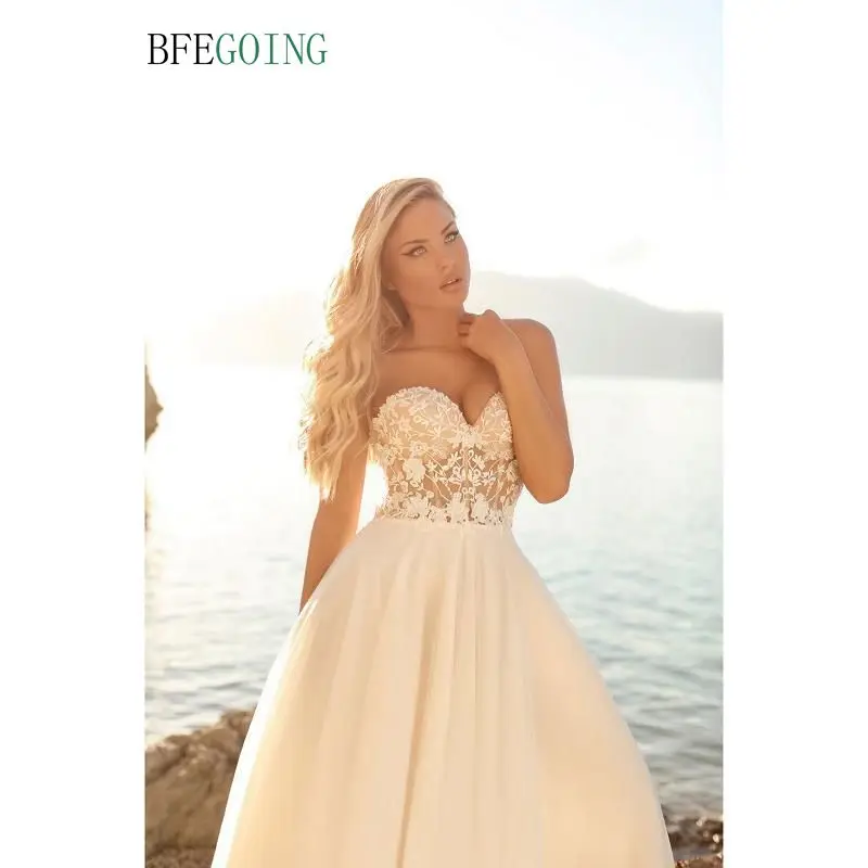 

Ivory Tulle Sweetheart Strapless Floor-Length A-Line Wedding Dresses Chapel Train Custom Made Layered Skirt
