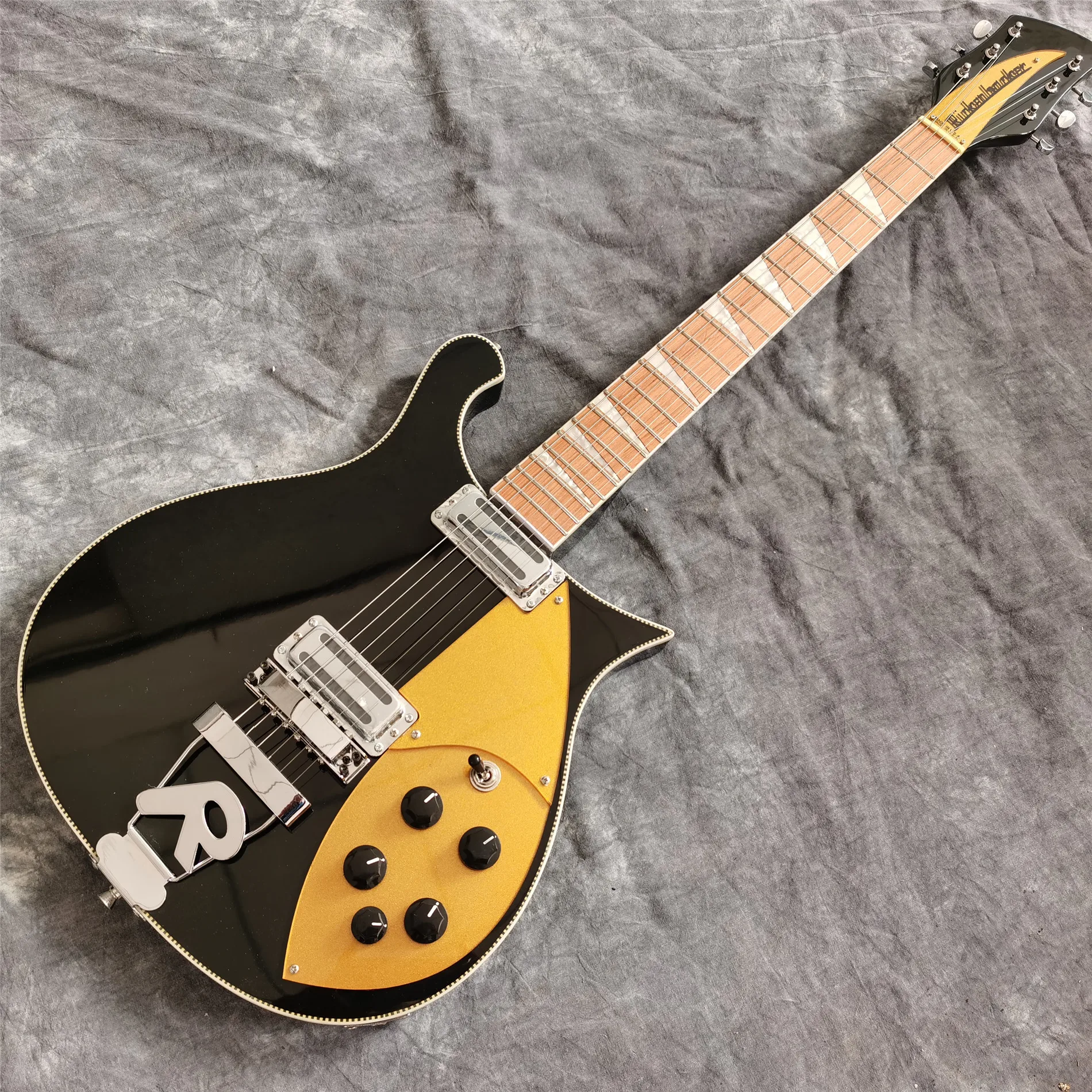 6 strings  660 electric guitar, black color with  R bridge, gold color pickguard,  chrome hardware , including freight