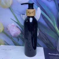 wholesale engraving 100pcs portable travel plastic black pump bottles with bamboo lid for shampoo cosmetic lotion container
