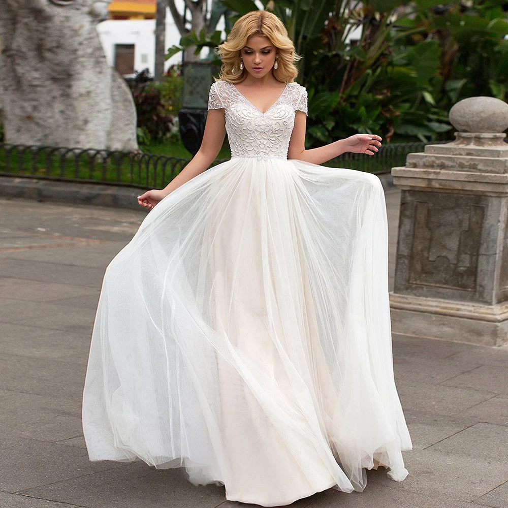 

2021 New A-Line Wedding Dresses Sexy V Neck Appliqued Cap Shoulder Backless Illusion Beading Floor Length Bridal Gowns