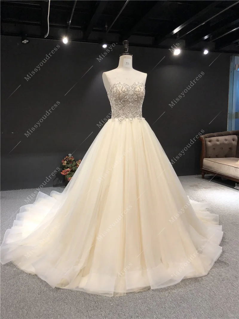 2021 Newest High Quality Real Sample Champagne Sweat Strapless Sleeveless Ball Gown Heavy Beadings Floor Length Wedding Dress