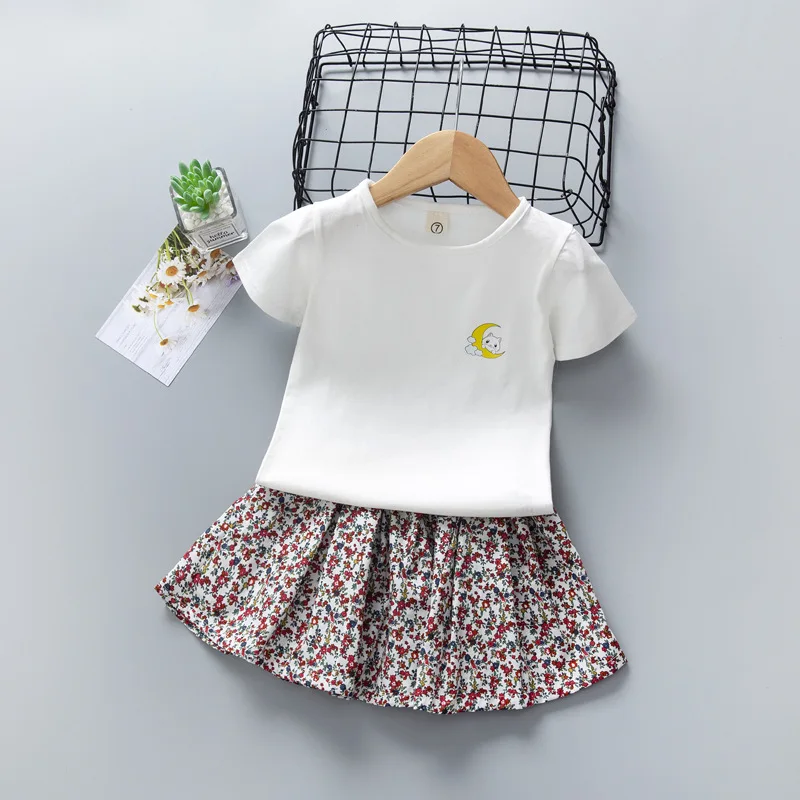 

Baby Girl Summer Set Short Sleeve 2 3 4 5 7 Years Cartoon White T-shirt Pleated Floral Skirt Two Piece Suit KF1036