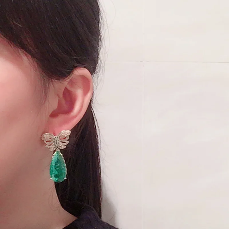

Golden butterfly earrings hollow super fairy emerald tourmaline earrings S925 silver needle temperament exaggerated earrings