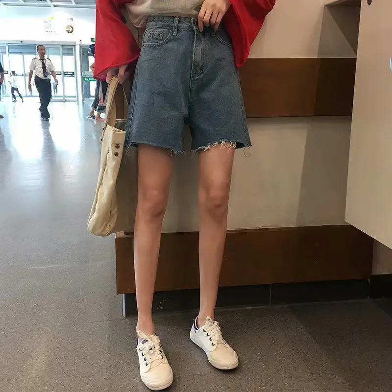 

Korean large asymmetric tassel perforated jeans shorts for female summer students