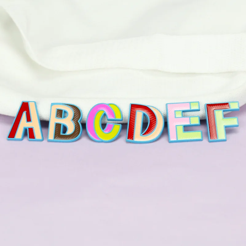 

26 cartoon metal badges with English letters, metal brooch badges, used for DIY decoration accessories for clothing backpacks