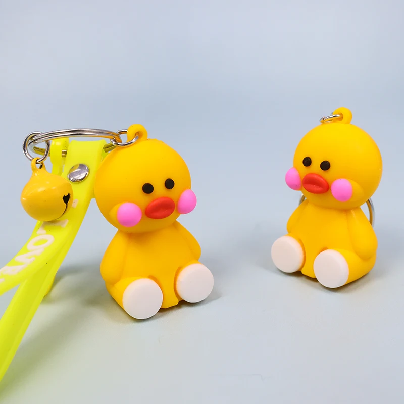 

Cute sitting cartoon little yellow duck key chain pendant soft rubber strip alloy small bell accessories small animal keychain