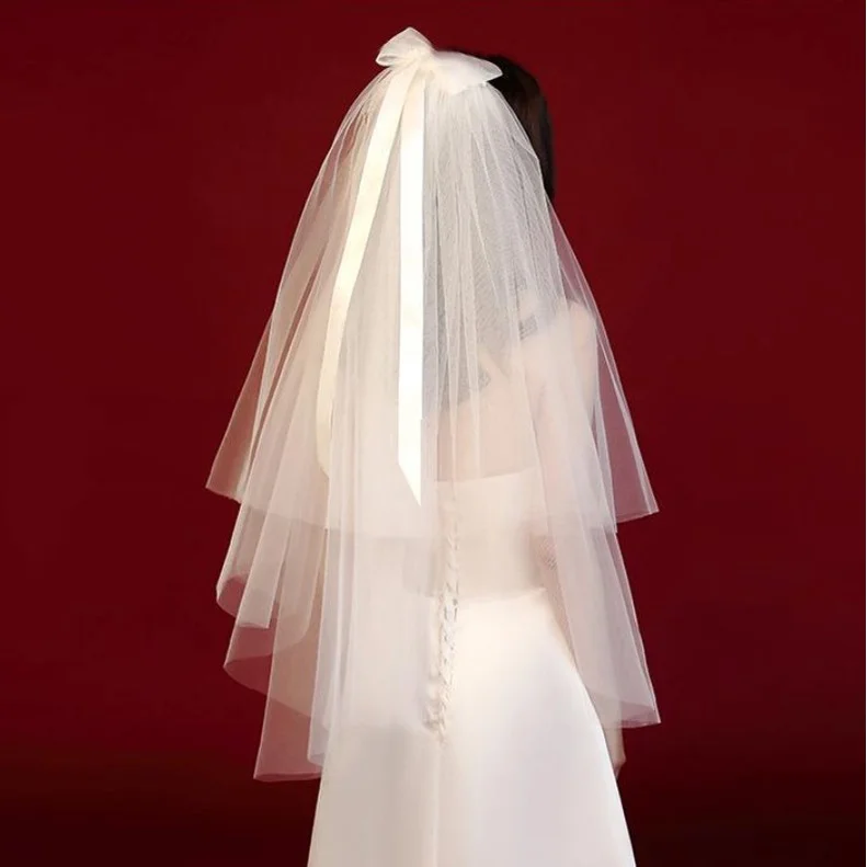 

Свадебная вуаль с бантом и жемчугом