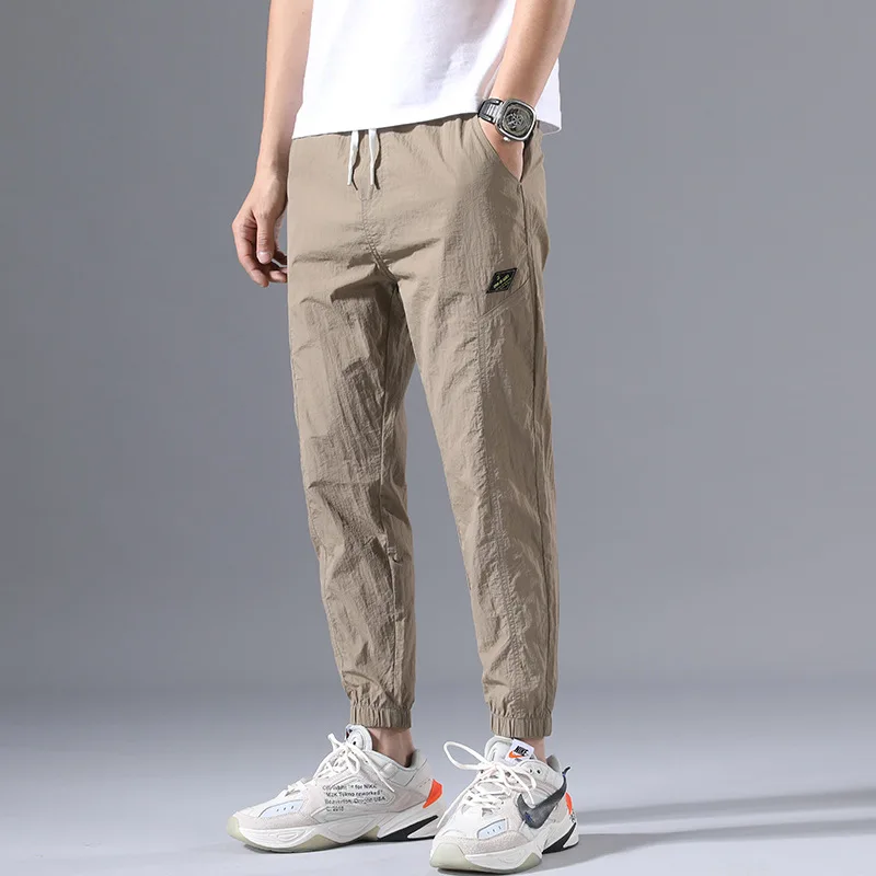 

Spring and summer thin men's Korean version leisure sports pants trend loose tooling binding feet ice silk nine men's pants