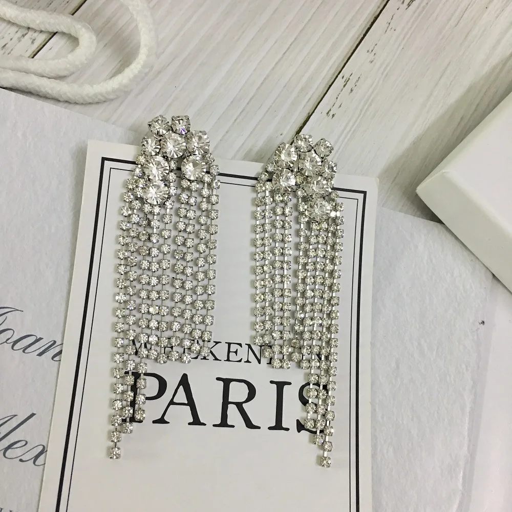 

Brass, platinum plated, full diamonds and crystal long flow comb earrings