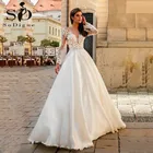 Платье свадебное атласное с длинными рукавами и кружевной аппликацией
