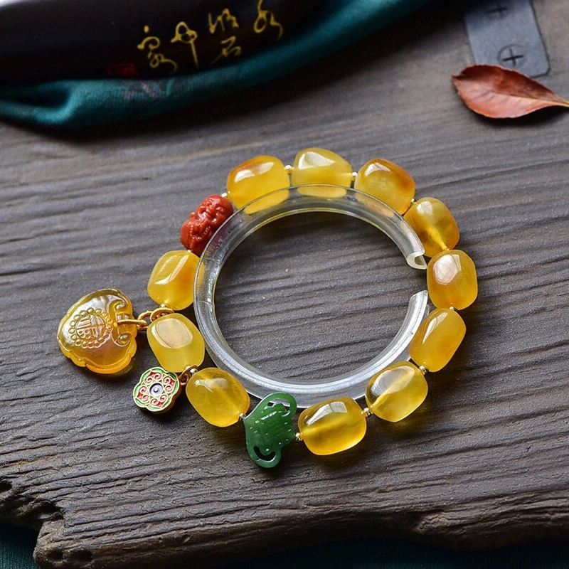 

Natural Gold Twisted Beeswax 11.9MM Shape Bracelet With Southern Red Agate Baby Buddha To Relieve Eye Fatigue