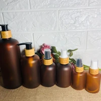 in stock 60ml 120ml 250ml 500ml 2 oz 4 oz 8 oz 16 7oz frosted amber pet plastic bottle with bamboo pump cap for lotion packaging