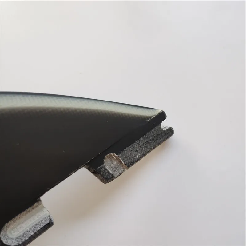 

surfing fin black and white fiberglass fin