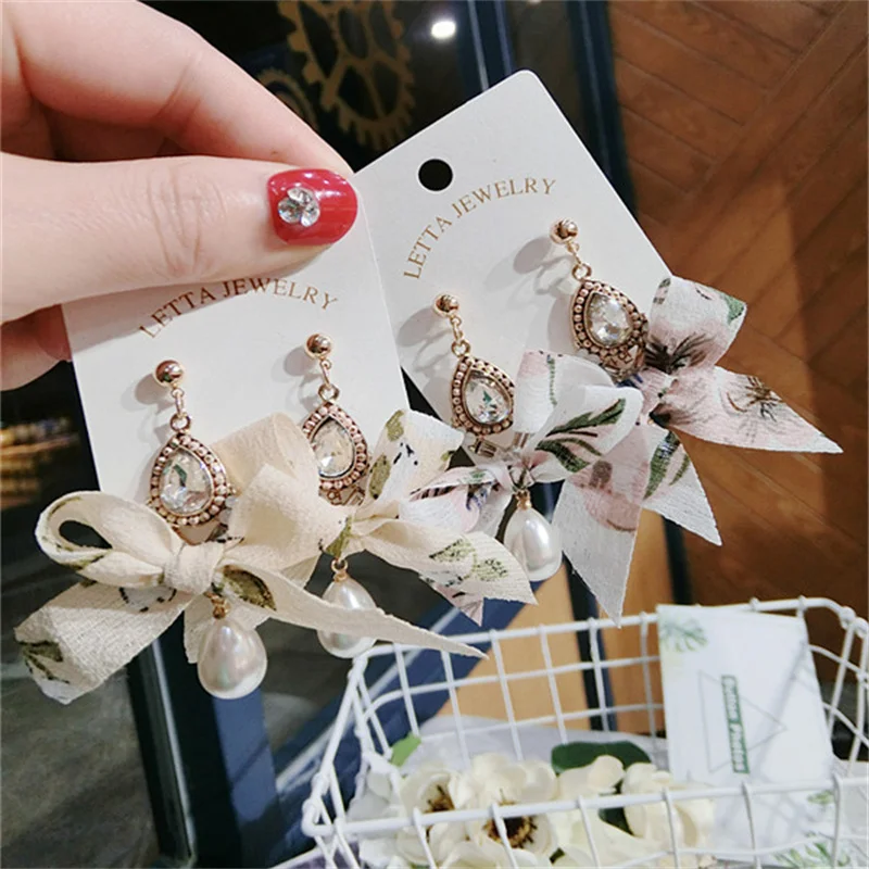 

Korean version of the new fashion chiffon floral pearl tassel earrings female pearl pendant charm bow earrings wholesale jewelry