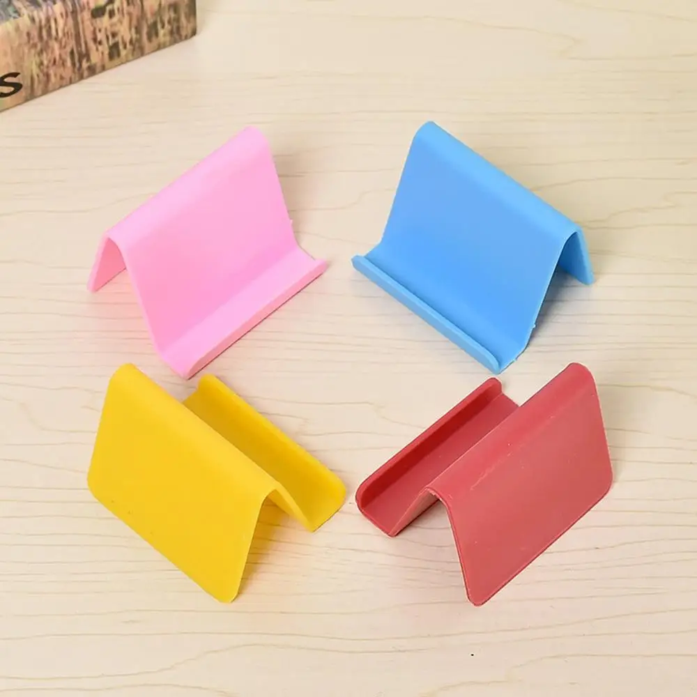 

2020 Hot Sales Candy Fixing BracketMini Phone Holder With Reserve Charging Hole Non-Slip Silicone Lazy Mobile Phone Stand