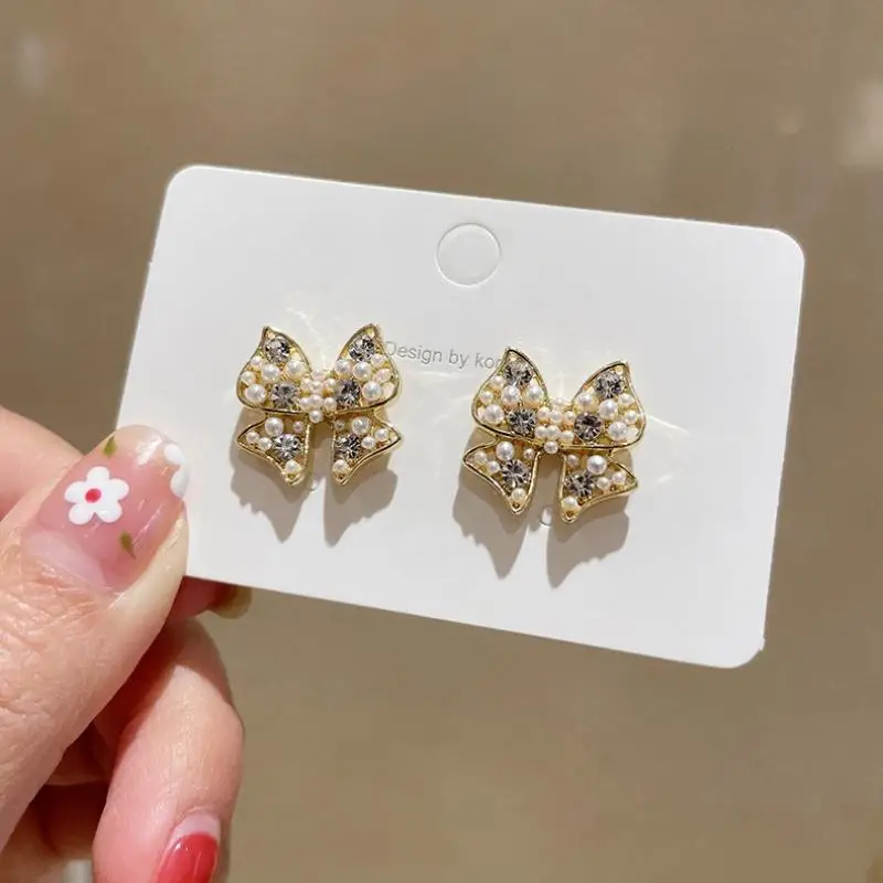 

XIAOBOACC Korean Fashion Earrings for Women Jewelry Simple Sweet Temperament Pearl Rhinestone Bow Ear Studs Free Shipping