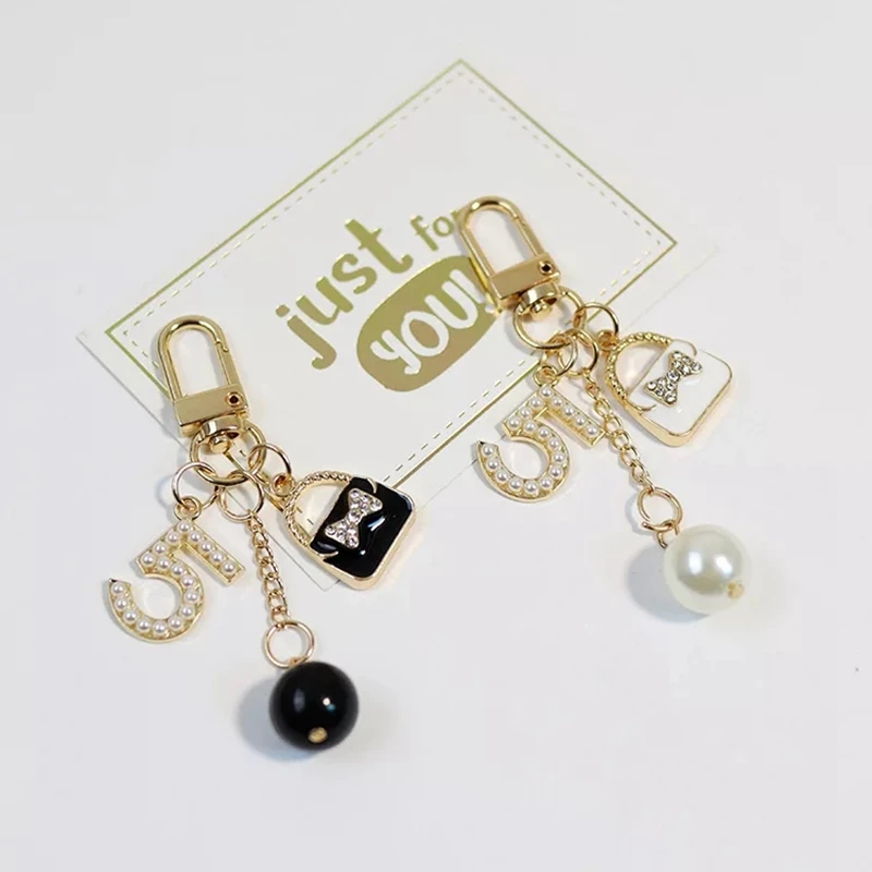 

2021 Imitated Pearl Perfume Gold Color Letter Alphabet Keychain For Women Key Chains Perfume bottle Pendant AirPods Accessories