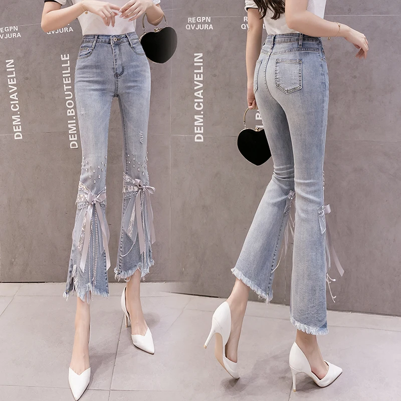 

2020 new autumn high waist irregular heavy industry beaded bowknot jeans female trumpet split fork skinny denim pants summer