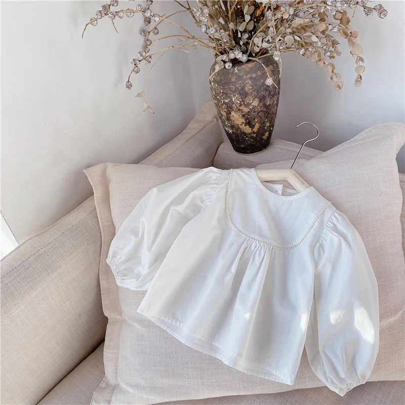 

2021 children's spring new girls' spring new Korean version bubble sleeve Lace Long Sleeve Shirt 21050