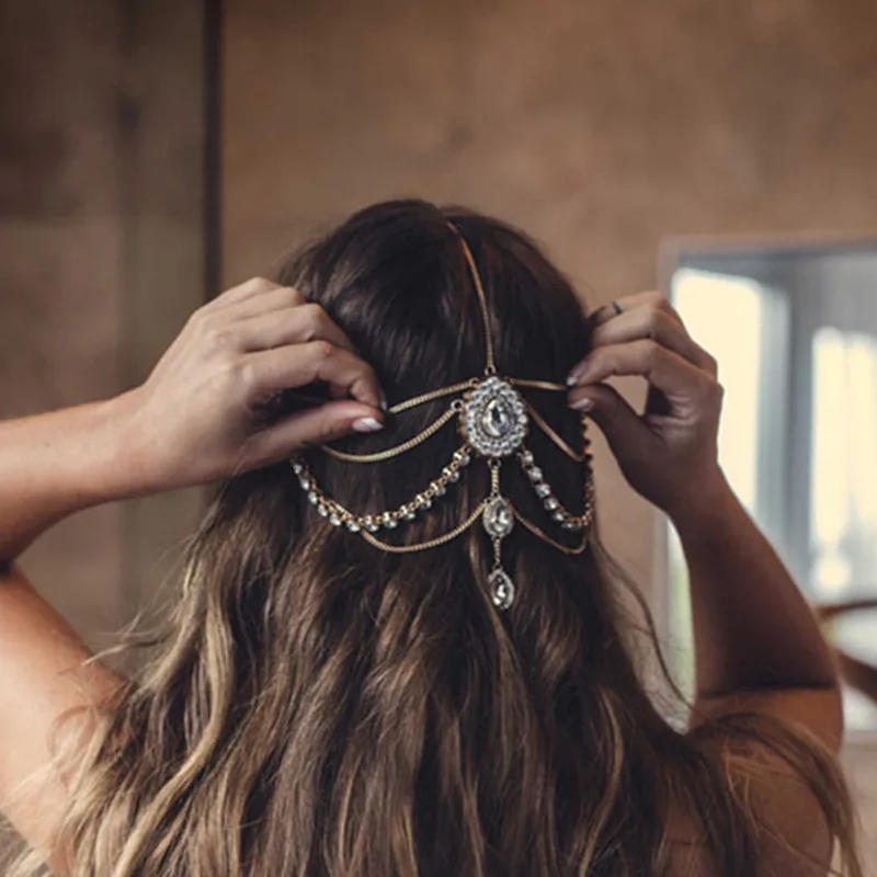 

Женская повязка на голову с перекрестными стразами, аксессуар для волос с крупными стразами в этническом стиле, цепочка с кисточками и драг...