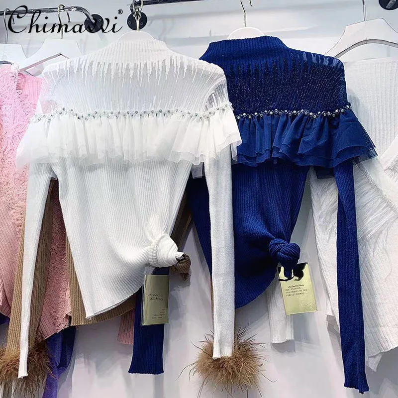 

Женский трикотажный свитер-водолазка с вышивкой бисером и оборками