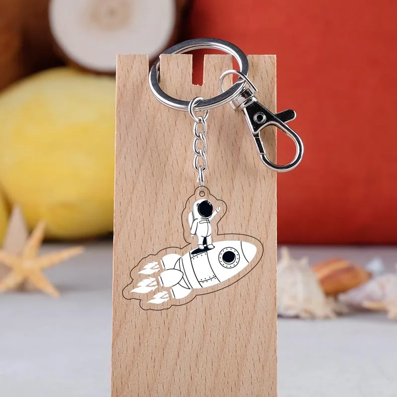 

Escape from the earth KeyChain UFO Space Craft Astronaut Rocket Planet Spaceman Universe Stars Acrylic Key Ring For Astrophile