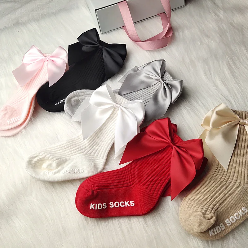 

Children's big bow in the middle of socks autumn winter big bowknot baby socks pure solid medium cylinder anti slip floor socks